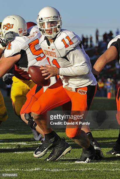 Quarterback Zac Robinson of the Oklahoma State Cowboys drops back during the game against the Iowa State Cyclones at Jack Trice Stadium on November...