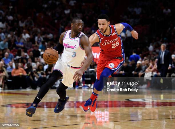 Dwyane Wade of the Miami Heat drives past Ben Simmons of the Philadelphia 76ers during the first half of the game at American Airlines Arena on March...