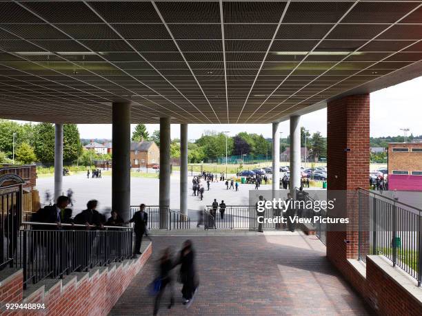 Canopied entrance with students arriving. Moseley School, Birmingham, United Kingdom. Architect: Penoyre & Prasad LLP, 2012.