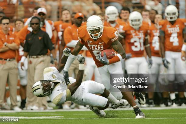 Wide receiver Malcolm Williams of the Texas Longhorns stiff arms cornerback Justin Boddie of the UCF Knights in the second quarter on November 7,...