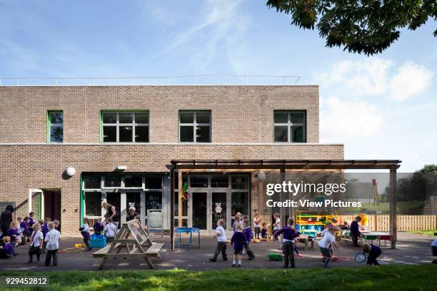 Square view of exterior of classroom and play area. Tiger Primary School, Maidstone, United Kingdom. Architect: Jestico + Whiles, 2011.