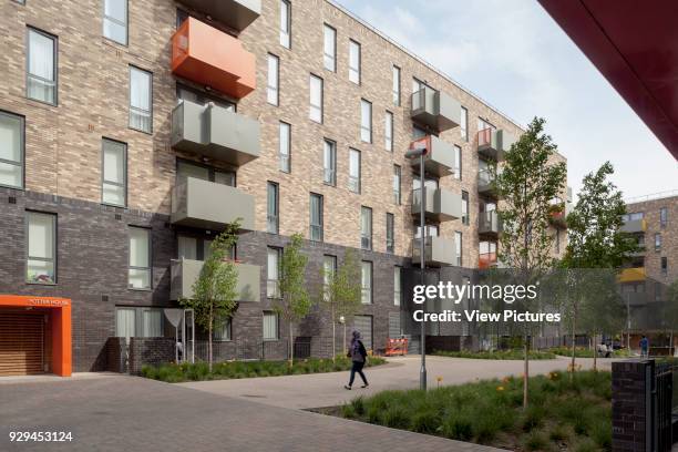 Angled view of central courtyard with figure. Ocean Estate, London, United Kingdom. Architect: Levitt Bernstein, 2015.