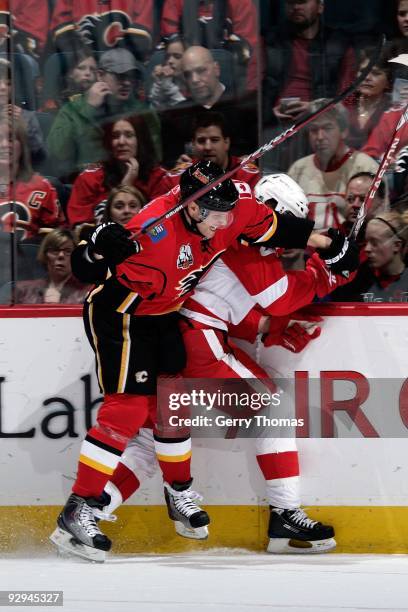 Dion Phaneuf of the Calgary Flames checks Todd Bertuzzi of the Detroit Red Wings on October 31, 2009 at Pengrowth Saddledome in Calgary, Alberta,...