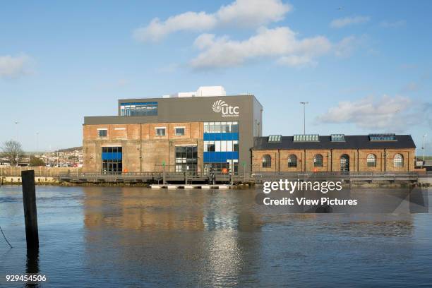 Elevation across harbour towards main facade. UTC Newhaven, Newhaven, United Kingdom. Architect: HKS Architects Limited, 2016.