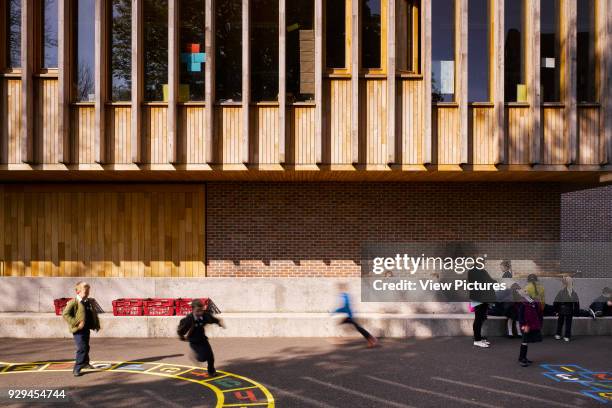 Close up view of playground with school children. Inchicore Model School, Inchicore, Ireland. Architect: Donaghy and Dimond Architects, 2015.