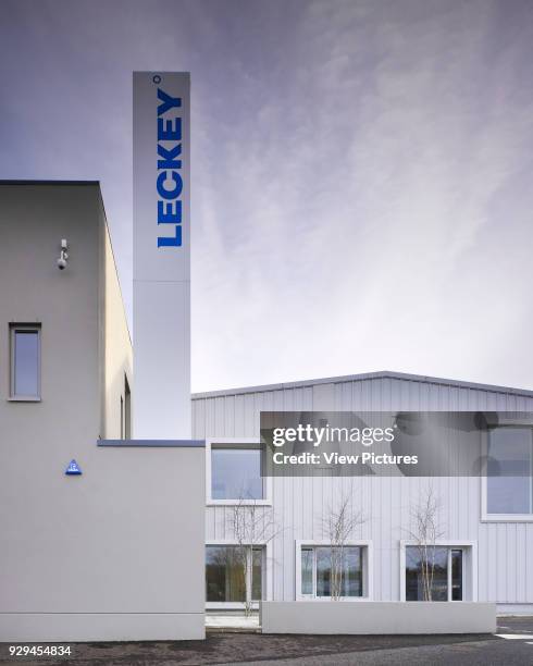View of entrance area showing branded column. Leckey Factory Offices, Lisburn, United Kingdom. Architect: Hall McKnight Architects, 2013.