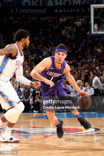 Devin Booker of the Phoenix Suns handles the ball during the game against the Oklahoma City Thunder on March 8, 2018 at Chesapeake Energy Arena in...
