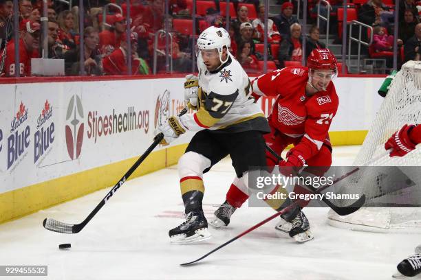 Brad Hunt of the Vegas Golden Knights battles for the puck with Dylan Larkin of the Detroit Red Wings during the second period at Little Caesars...