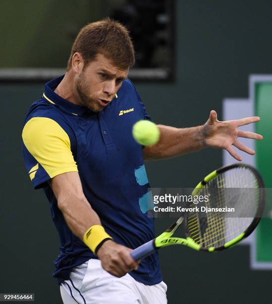 Ryan Harrison, of United States, returns against Frederico Delbonis, of Argentina, during Day 4 of the BNP Paribas Open on March 8, 2018 in Indian...
