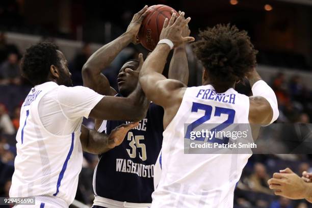 Bo Zeigler of the George Washington Colonials is defended by D.J. Foreman of the Saint Louis Billikens during the first half in the Second Round of...