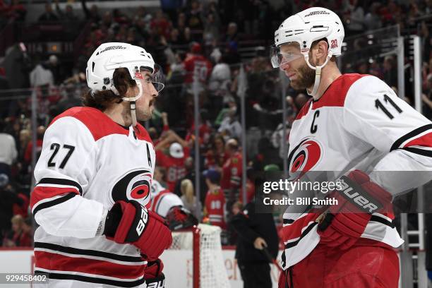 Justin Faulk and Jordan Staal of the Carolina Hurricanes talk in the first period against the Chicago Blackhawks at the United Center on March 8,...