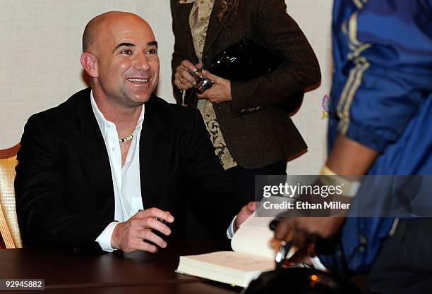 Former tennis player Andre Agassi signs copies of his new autobiography, "Open" at the Encore Theater at Wynn Las Vegas November 9, 2009 in Las...