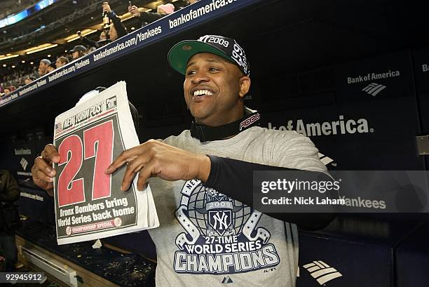 Sabathia of the New York Yankees celebrates in the dugout with a copy of the New York Post after their 7-3 win against the Philadelphia Phillies in...