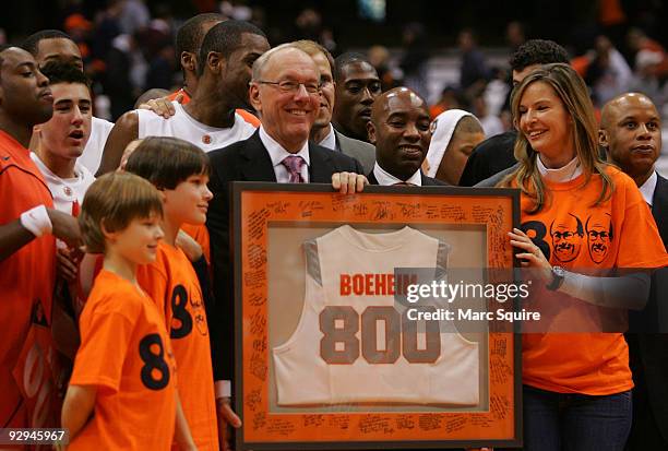 Coach Jim Boeheim, Juli Boeheim, and the Syracuse Basketball team celebrate the 800th win after the game against the Albany Great Danes on November...