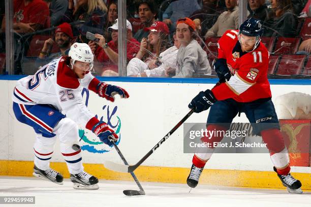 Jonathan Huberdeau of the Florida Panthers passes the puck against Jacob de la Rose of the Montreal Canadiens at the BB&T Center on March 8, 2018 in...