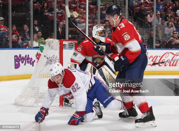 Artturi Lehkonen of the Montreal Canadiens is taken to the ice by Mark Pysyk of the Florida Panthers next to the net during second period action at...