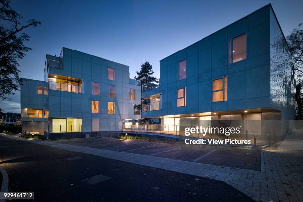 Dusk wide view of exterior showing lit interior. Dunluce Apartments, Ballsbridge, Ireland. Architect: Derek Tynan Architects, 2016.