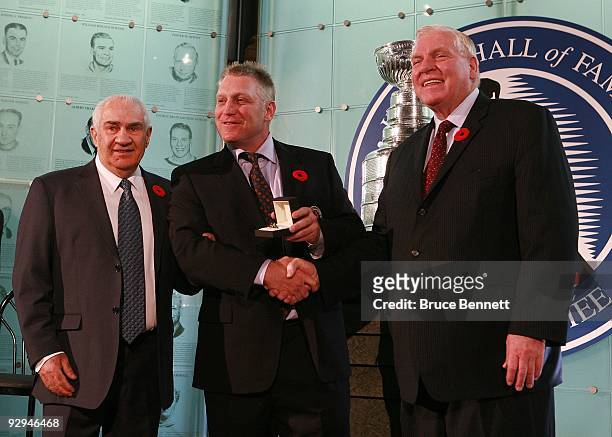 Jim Gregory and Bill Hay present Brett Hull with his Hall of Fame ring at the Hockey Hall of Fame Induction Photo Opportunity at the Hockey Hall of...
