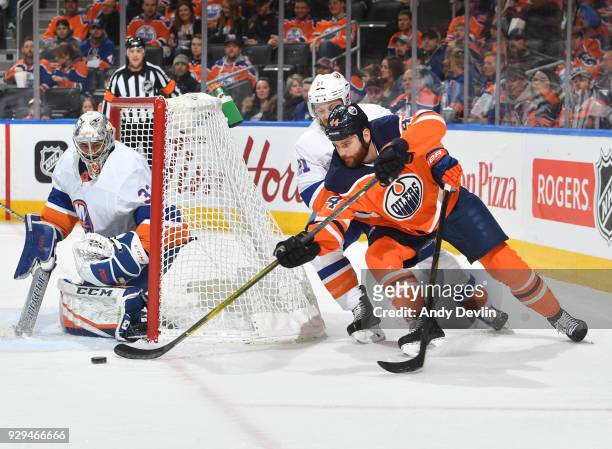 Zack Kassian of the Edmonton Oilers attempts a wrap around shot on Christopher Gibson of the New York Islanders on March 8, 2018 at Rogers Place in...