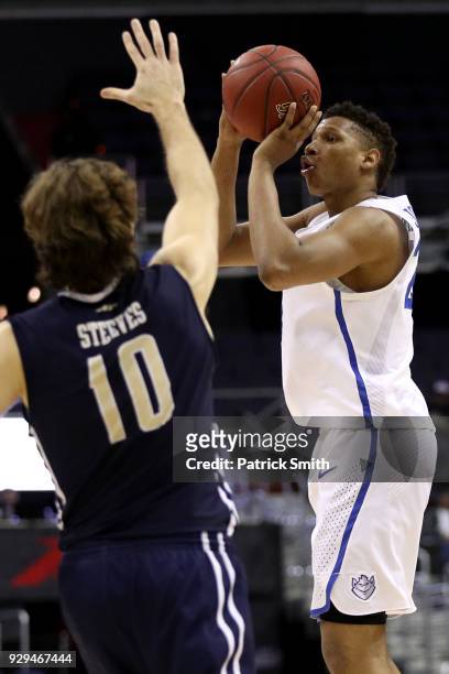 Jalen Johnson of the Saint Louis Billikens shoots a three-pointer in front of Patrick Steeves of the George Washington Colonials during the second...