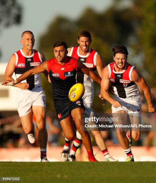 Christian Salem of the Demons and Jack Steven of the Saints compete for the ball during the AFL 2018 JLT Community Series match between the Melbourne...