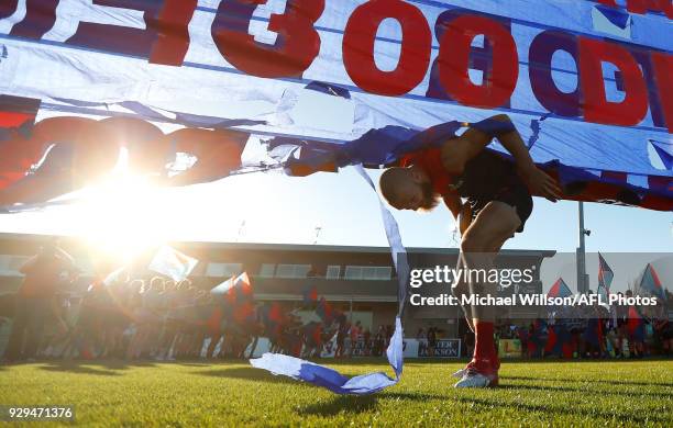 Max Gawn of the Demons runs through the banner during the AFL 2018 JLT Community Series match between the Melbourne Demons and the St Kilda Saints at...