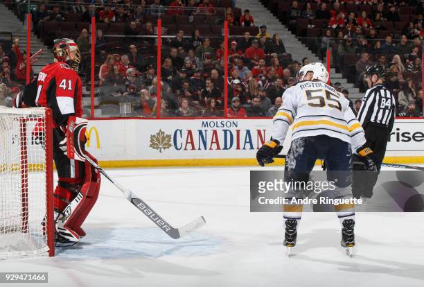 Craig Anderson of the Ottawa Senators and Rasmus Ristolainen of the Buffalo Sabres have words during overtime at Canadian Tire Centre on March 8,...