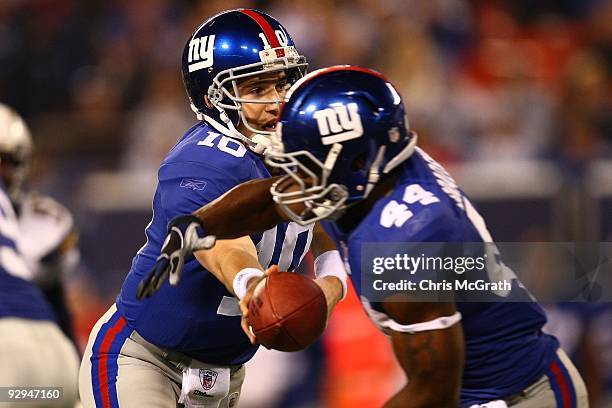 Eli Manning of the New York Giants hands the ball off to Ahmad Bradshaw against the San Diego Chargers on November 8, 2009 at Giants Stadium in East...