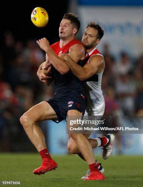 Jesse Hogan of the Demons is tackled by Nathan Brown of the Saints during the AFL 2018 JLT Community Series match between the Melbourne Demons and...