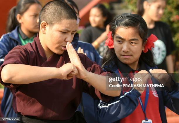 Buddhist nun teaches kung fu to Nepali school students at the Amitabha Drukpa Nunnery during International Women's Day on the outskirts of Kathmandu...