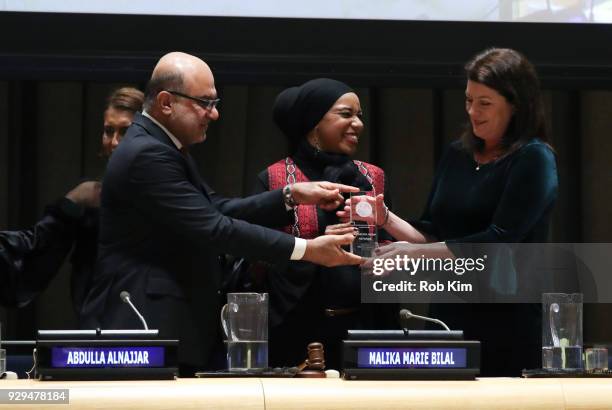 Abdulla Alnajjar, Malika Marie Bilal and Patricia Anne Culhane accept an award at the International Women's Day The Role of Media To Empower Women...