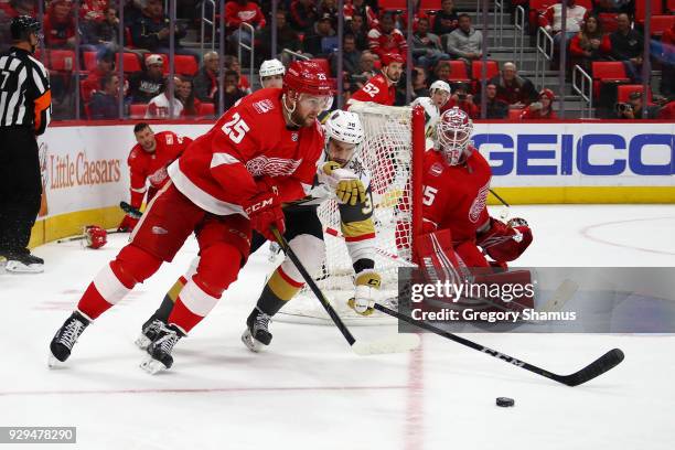 Mike Green of the Detroit Red Wings tries to control the puck in front of Tomas Hyka of the Vegas Golden Knights during the third period at Little...