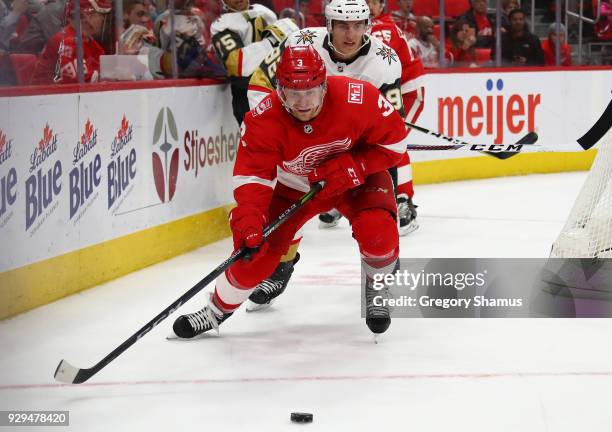 Nick Jensen of the Detroit Red Wings chases down the puck in front of Tomas Nosek of the Vegas Golden Knights during the third period at Little...