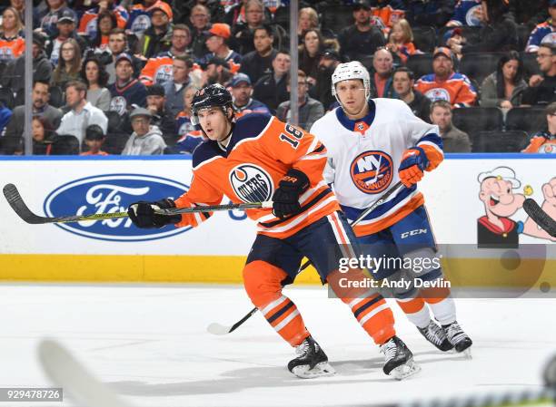 Ryan Strome of the Edmonton Oilers battles for the puck against Tanner Fritz of the New York Islanders on March 8, 2018 at Rogers Place in Edmonton,...