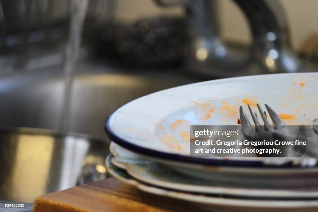 Untidy House -Dirty Dishes At Sink.