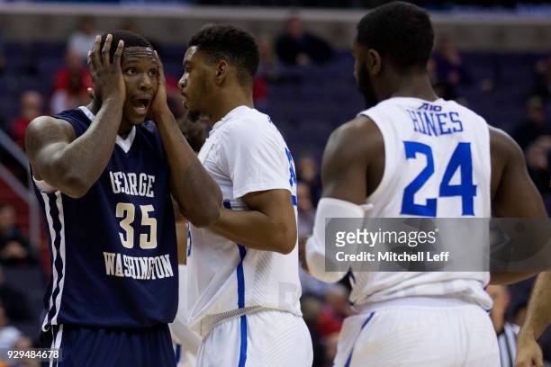 Bo Zeigler of the George Washington Colonials reacts in front of Aaron Hines of the Saint Louis Billikens in the second round of the Atlantic 10...