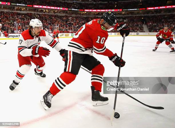 Patrick Sharp of the Chicago Blackhawks controls the puck in front of Justin Faulk of the Carolina Hurricanes at the United Center on March 8, 2018...