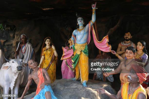Grotto with statues depicting the life of Krishna in the courtyard of a Vrindavan temple. India.