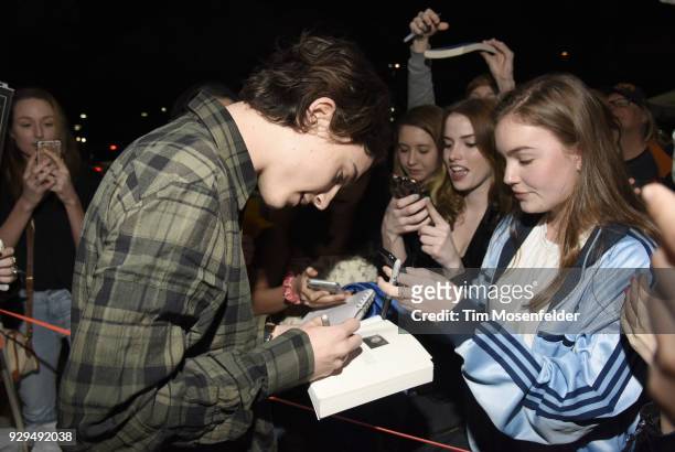 Timothee Chalamet signs autographs for fans at the 2018 Texas Film Awards at AFS Cinema on March 8, 2018 in Austin, Texas.