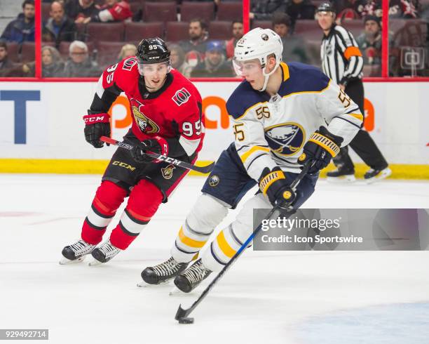 Buffalo Sabres Defenceman Rasmus Ristolainen stickhandles the puck as Ottawa Senators Center Matt Duchene chases it down during over-time period of...