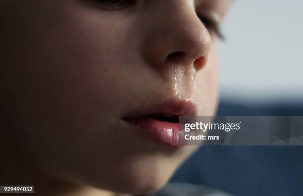 child with a runny nose - sonarse fotografías e imágenes de stock