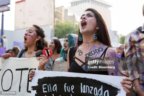 Demonstrators hold signs during a national strike on International Women's Day in Mexico City, Mexico, on Thursday, March 8, 2018. The United Nations...