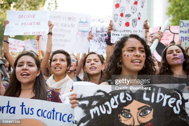 Demonstrators hold signs during a national strike on International Women's Day in Mexico City, Mexico, on Thursday, March 8, 2018. The United Nations...