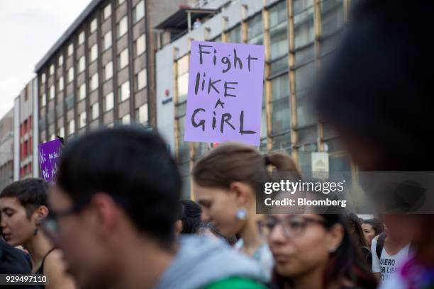 Demonstrators holds a sign that reads "Fight like a girl" during a national strike on International Women's Day in Mexico City, Mexico, on Thursday,...