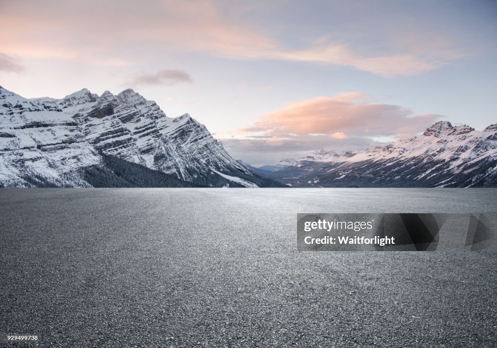 Empty road with snowcapped mountain background