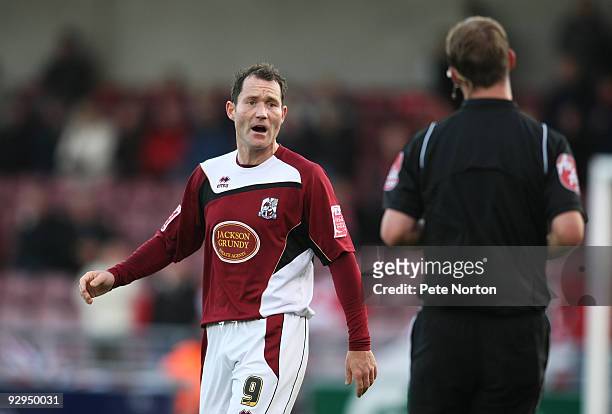 Steve Guinan of Northampton Town makes a point to referee Bobby Madley during the FA Cup sponsored by e:on First Round Match between Northampton Town...