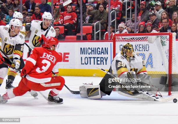 Vegas Golden Knights Goalie Marc-Andre Fleury steers aside the puck as Detroit Red Wings Defenceman Nick Jensen looks for the rebound in the NHL...