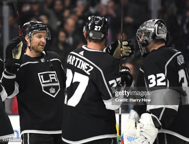 Trevor Lewis of the Los Angeles Kings celebrates a 3-1 win over the Washington Capitals with Jonathan Quick and Alec Martinez at Staples Center on...