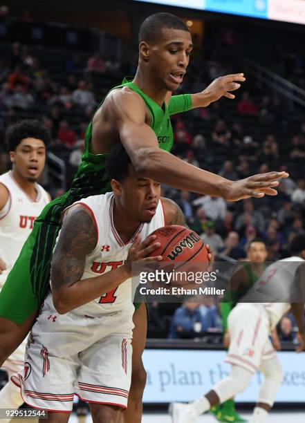 Kenny Wooten of the Oregon Ducks fouls Justin Bibbins of the Utah Utes after he stole the ball from Wooten during a quarterfinal game of the Pac-12...