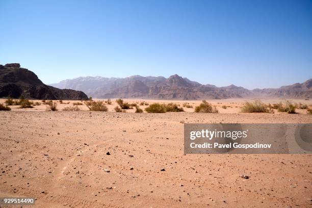 dramatic sandstone mountains and steep cliffs in wadi rum (the valley of the moon), a protected desert wilderness in jordan - desert mountain range stock pictures, royalty-free photos & images